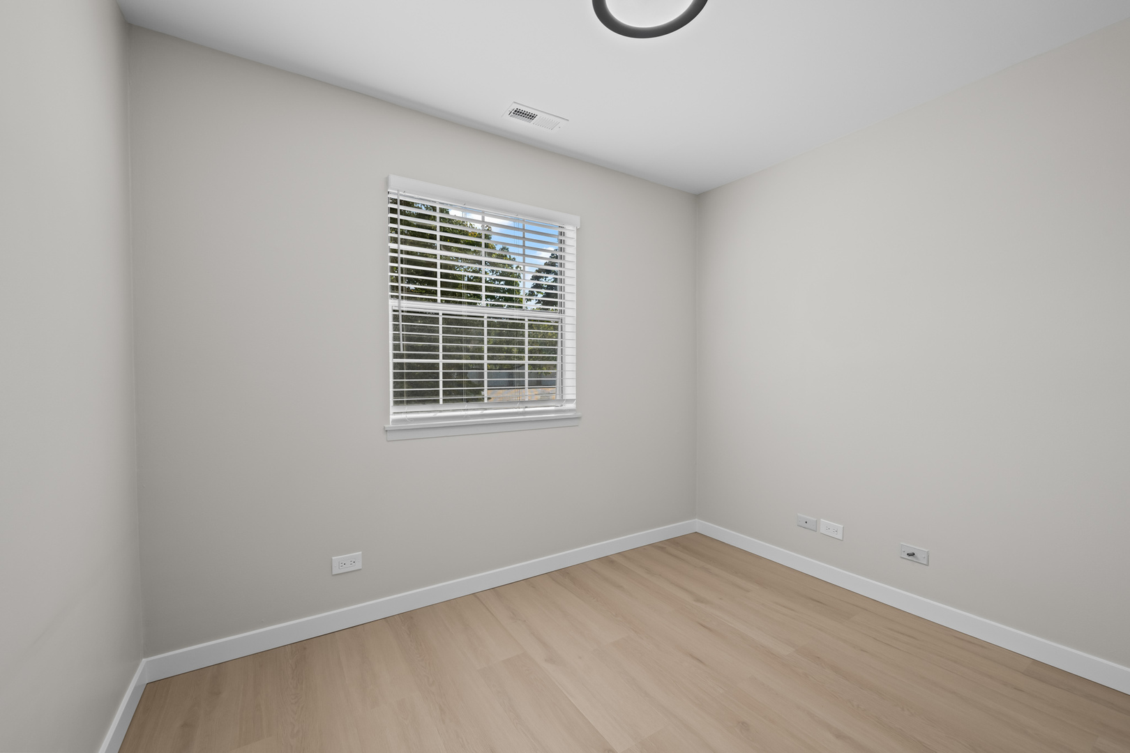 556 East Shag Bark Lane, Unit C Streamwood, IL 60107 - Photo 9 of 15 a view of an empty room with a window