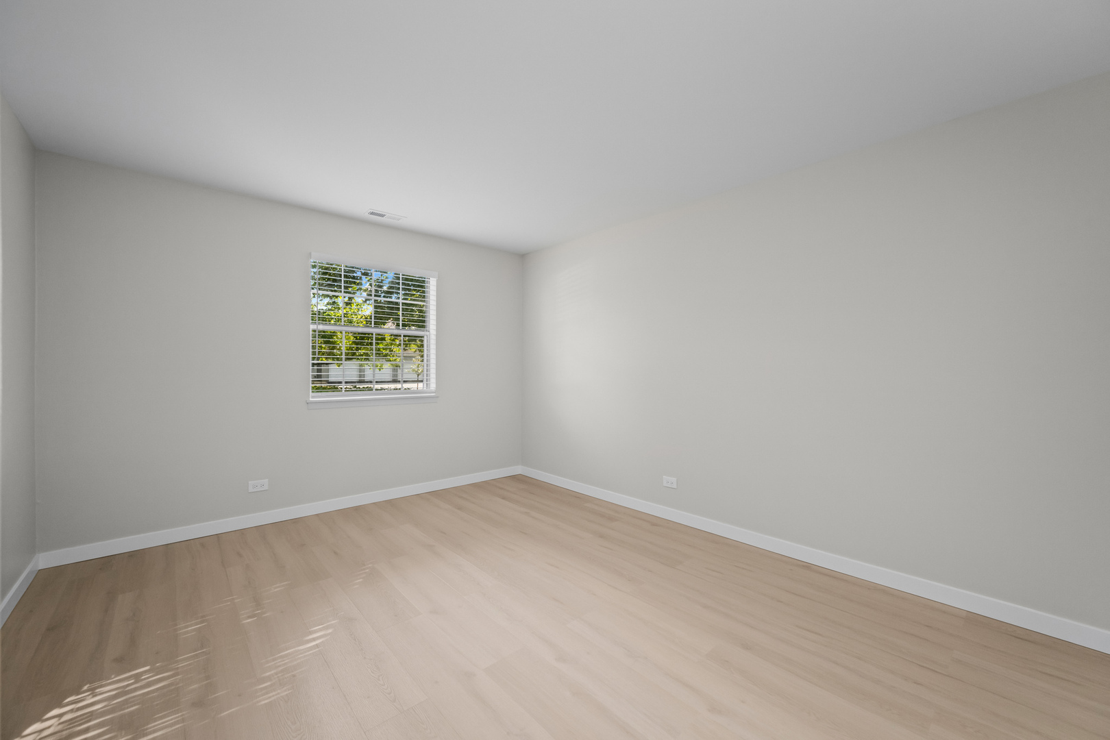 556 East Shag Bark Lane, Unit C Streamwood, IL 60107 - Photo 10 of 15 an empty room with a window