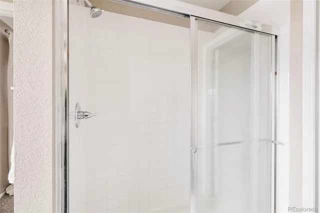 a bathroom with a shower and a shower curtain