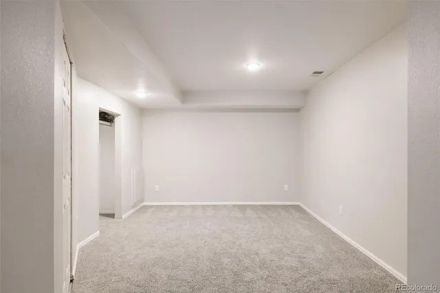 an empty room with a empty space and windows