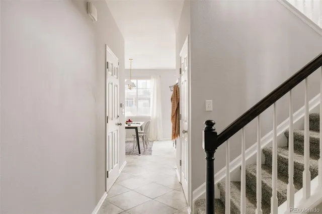 a view of a hallway with dining area and chandelier