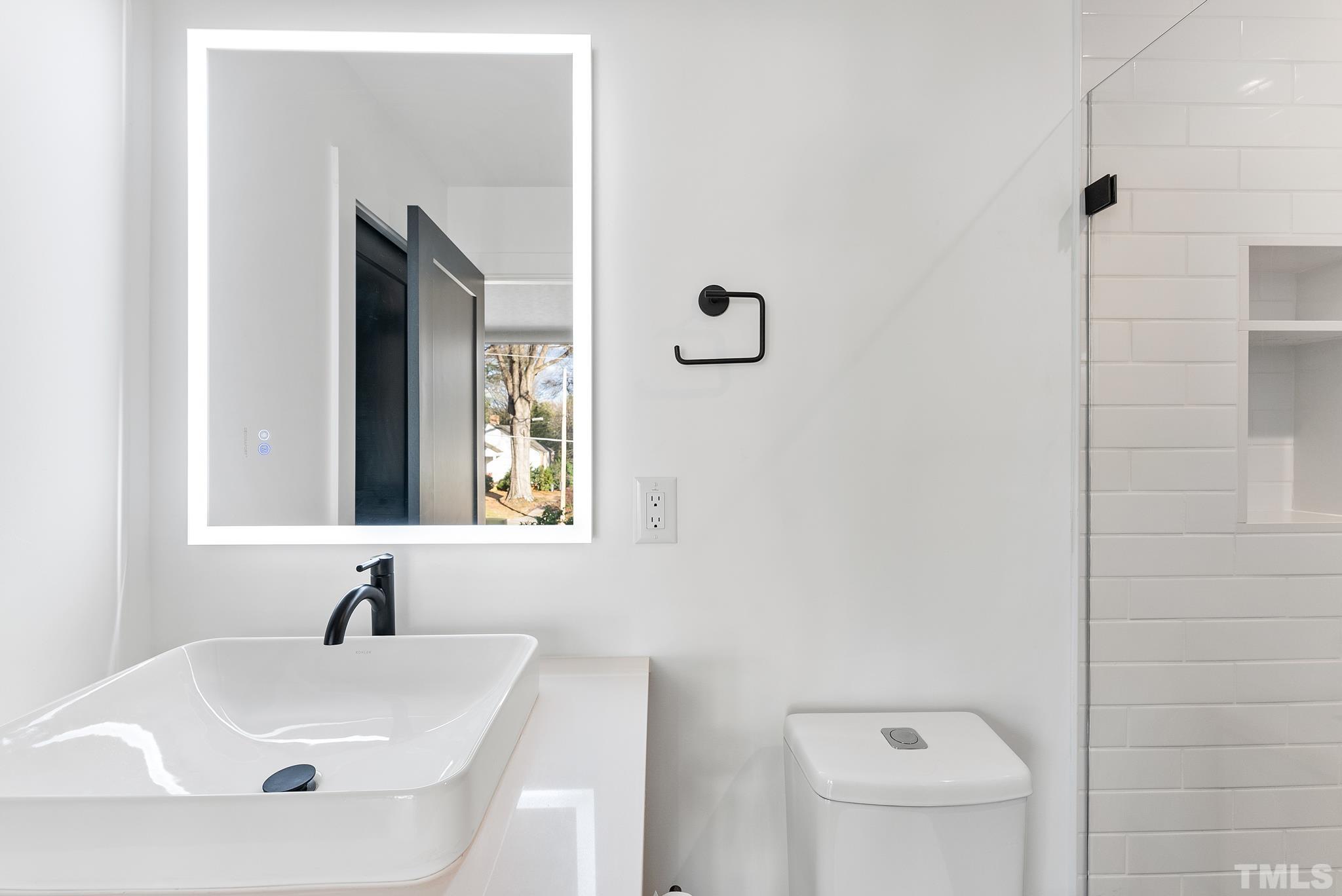 2511 Stafford Avenue Raleigh, NC 27607 - Photo 36 of 74 a bathroom with a sink a toilet and a mirror
