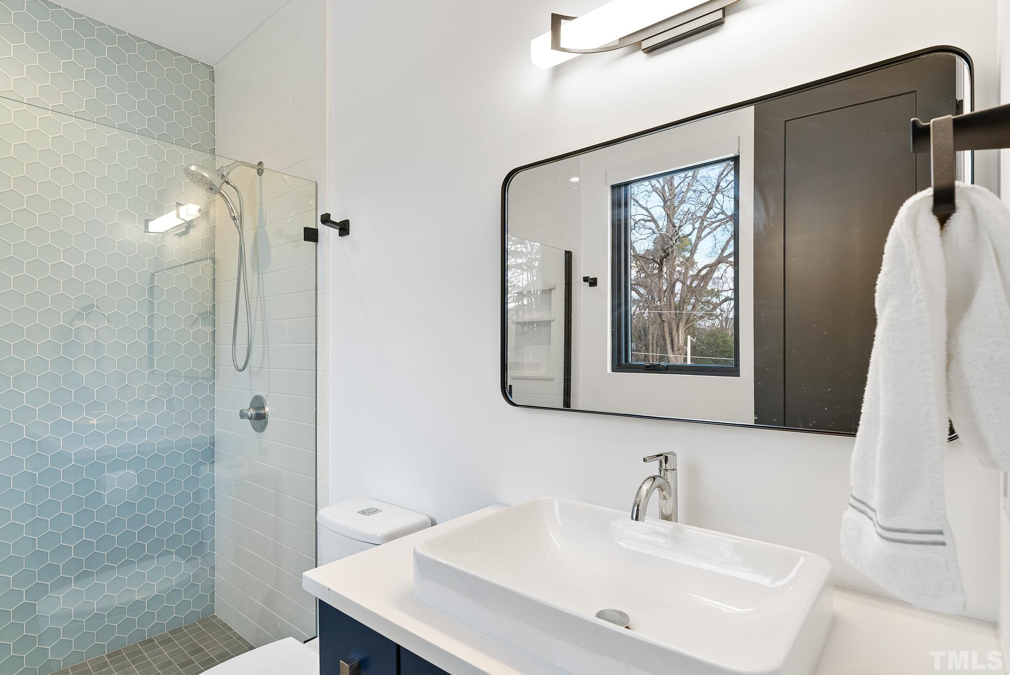 2511 Stafford Avenue Raleigh, NC 27607 - Photo 54 of 74 a bathroom with a sink a mirror and a shower