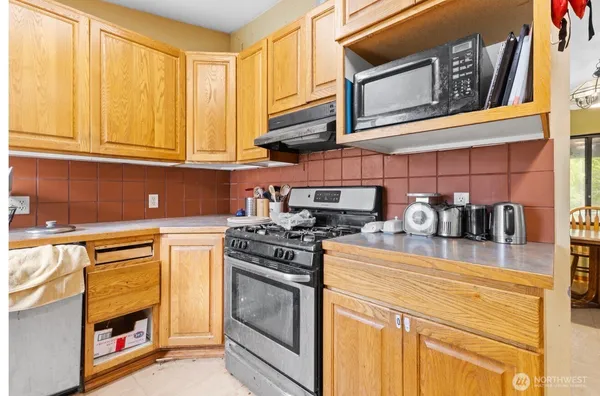 a kitchen with refrigerator and cabinets