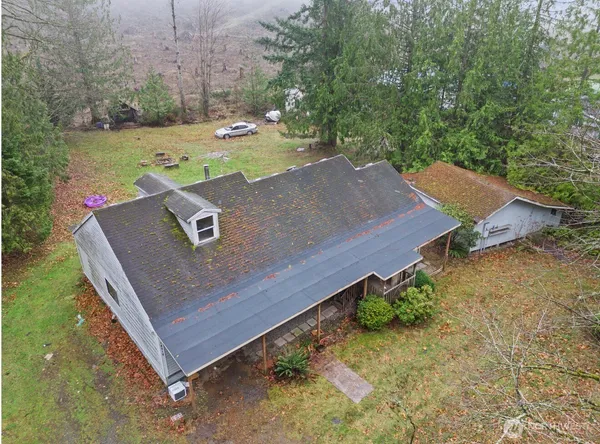 an aerial view of a house with a yard
