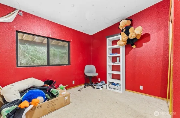 a bed room with a bed and a painting on the wall