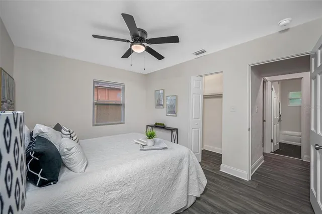 a bedroom with a bed and wooden floor