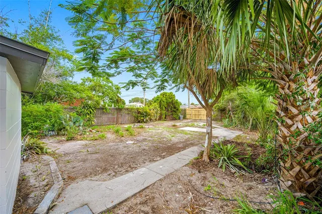 a view of a house with a yard and a garage