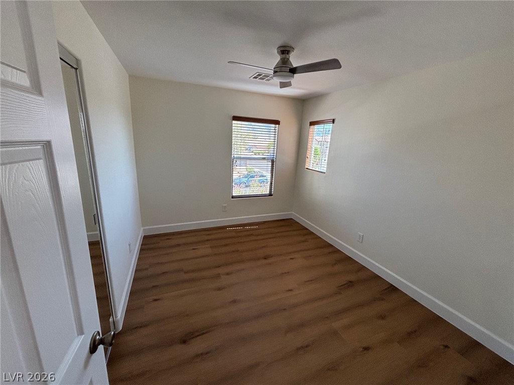 4900 Naff Ridge Drive Las Vegas, NV 89131 - Photo 15 of 21 Rich hardwood-style flooring and multiple windows create an inviting, naturally lit personal space.