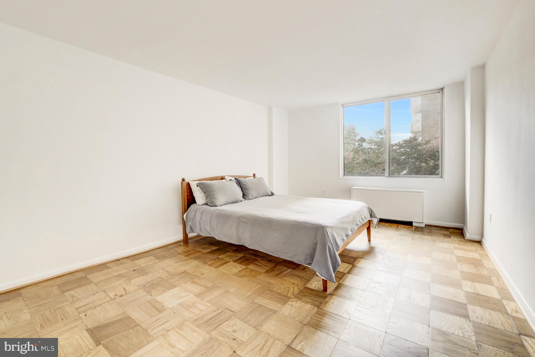 2939 Van Ness Street Northwest, Unit 727 Washington, DC 20008 - Photo 11 of 31 a spacious bedroom with a bed and a window