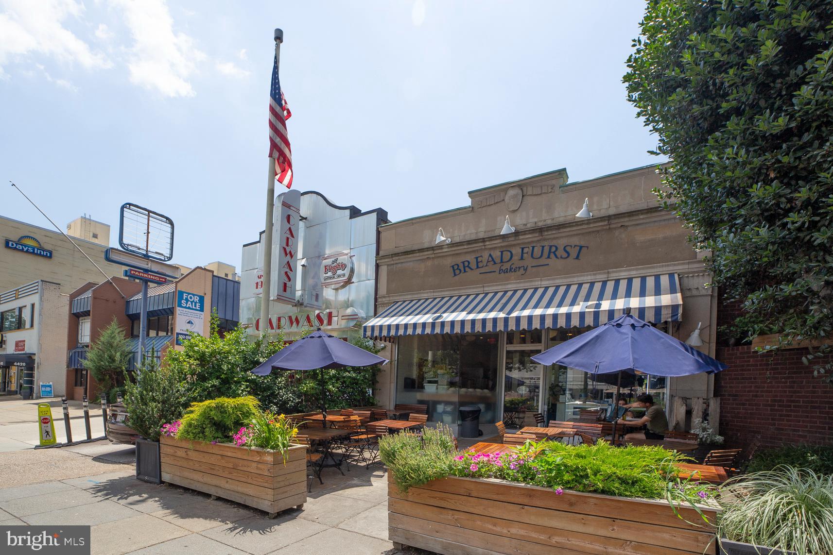 2939 Van Ness Street Northwest, Unit 727 Washington, DC 20008 - Photo 26 of 31 a front view of a building with small garden