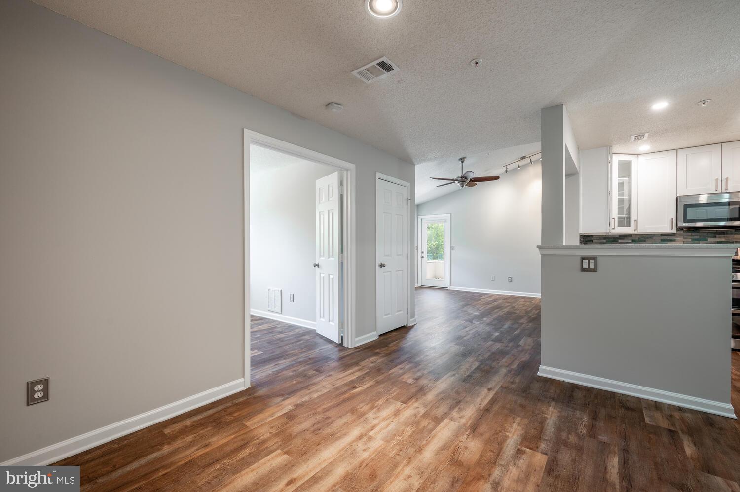 12024 Taliesin Place, Unit 33 Reston, VA 20190 - Photo 2 of 32 a view of a kitchen with a refrigerator and wooden floor
