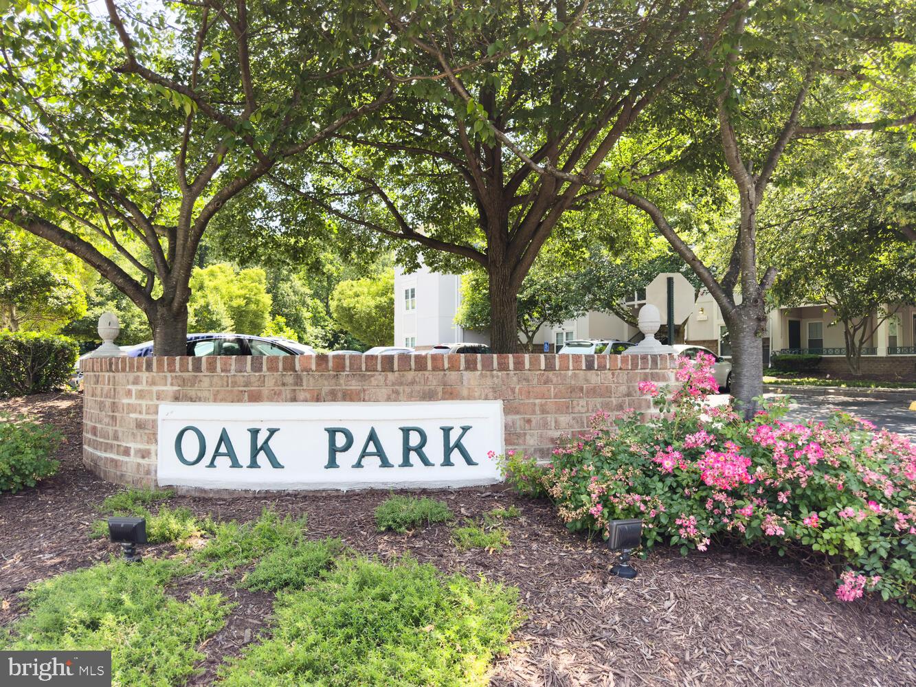 12024 Taliesin Place, Unit 33 Reston, VA 20190 - Photo 28 of 32 a sign that is sitting in front of flowers