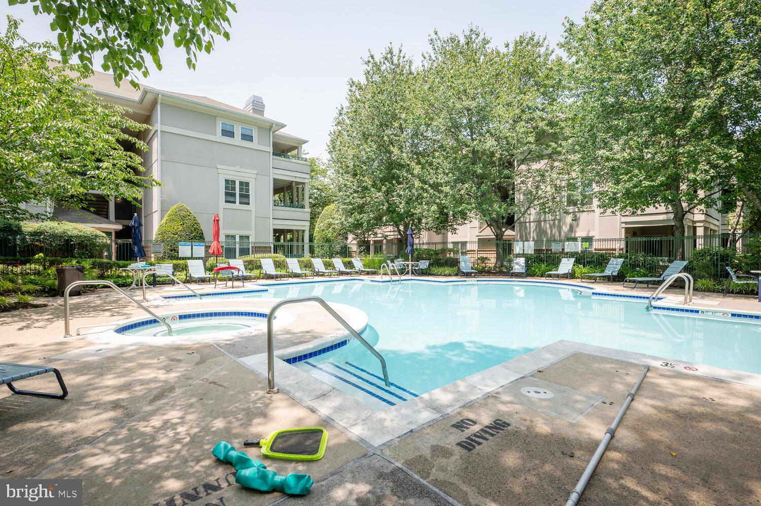 12024 Taliesin Place, Unit 33 Reston, VA 20190 - Photo 29 of 32 a swimming pool with outdoor seating and yard