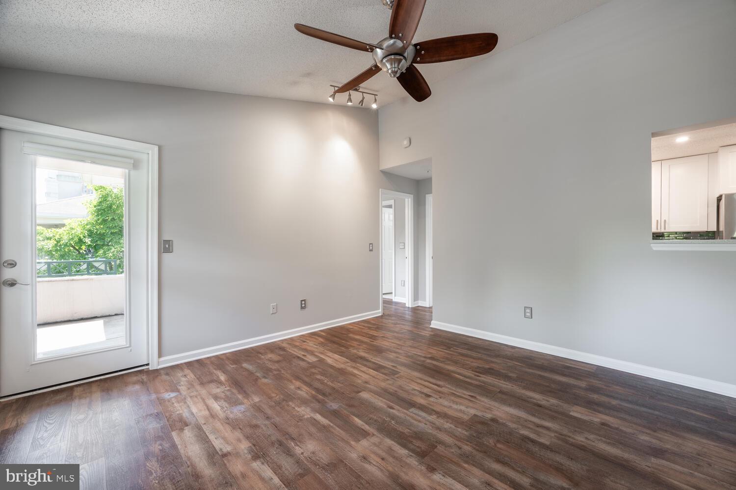 12024 Taliesin Place, Unit 33 Reston, VA 20190 - Photo 4 of 32 an empty room with wooden floor fan and windows