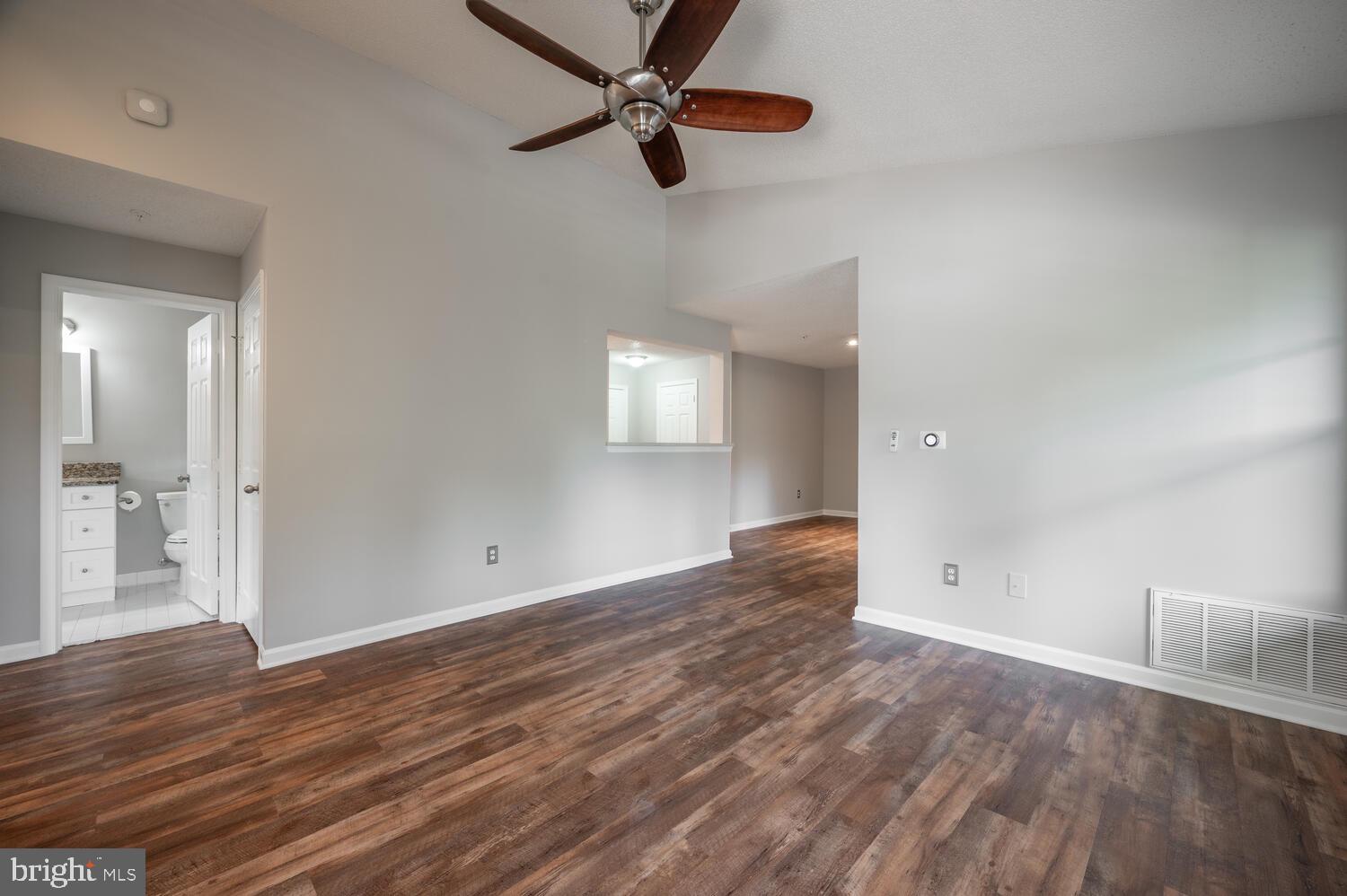 12024 Taliesin Place, Unit 33 Reston, VA 20190 - Photo 5 of 32 wooden floor in an empty room with a window