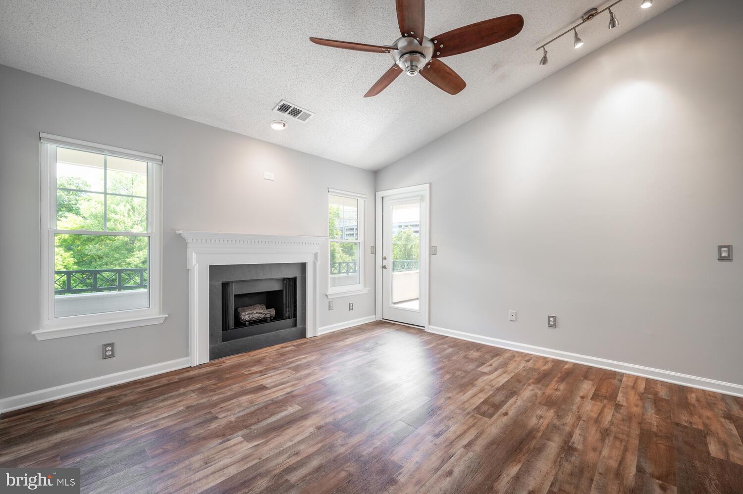 12024 Taliesin Place, Unit 33 Reston, VA 20190 - Photo 7 of 32 a view of empty room with wooden floor and fireplace