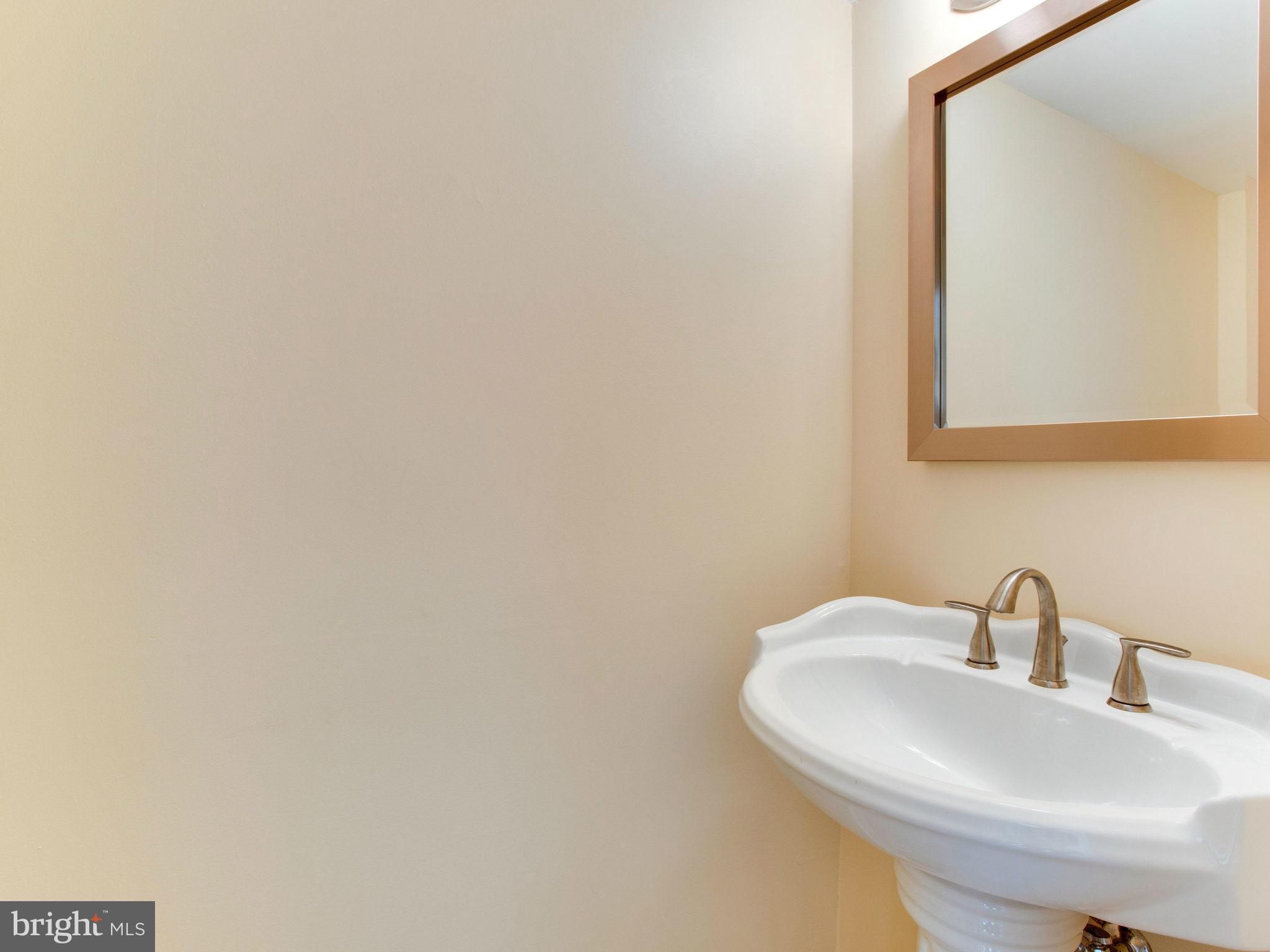2308 St Bedes Court Reston, VA 20191 - Photo 13 of 30 a bathroom with a sink a mirror and vanity