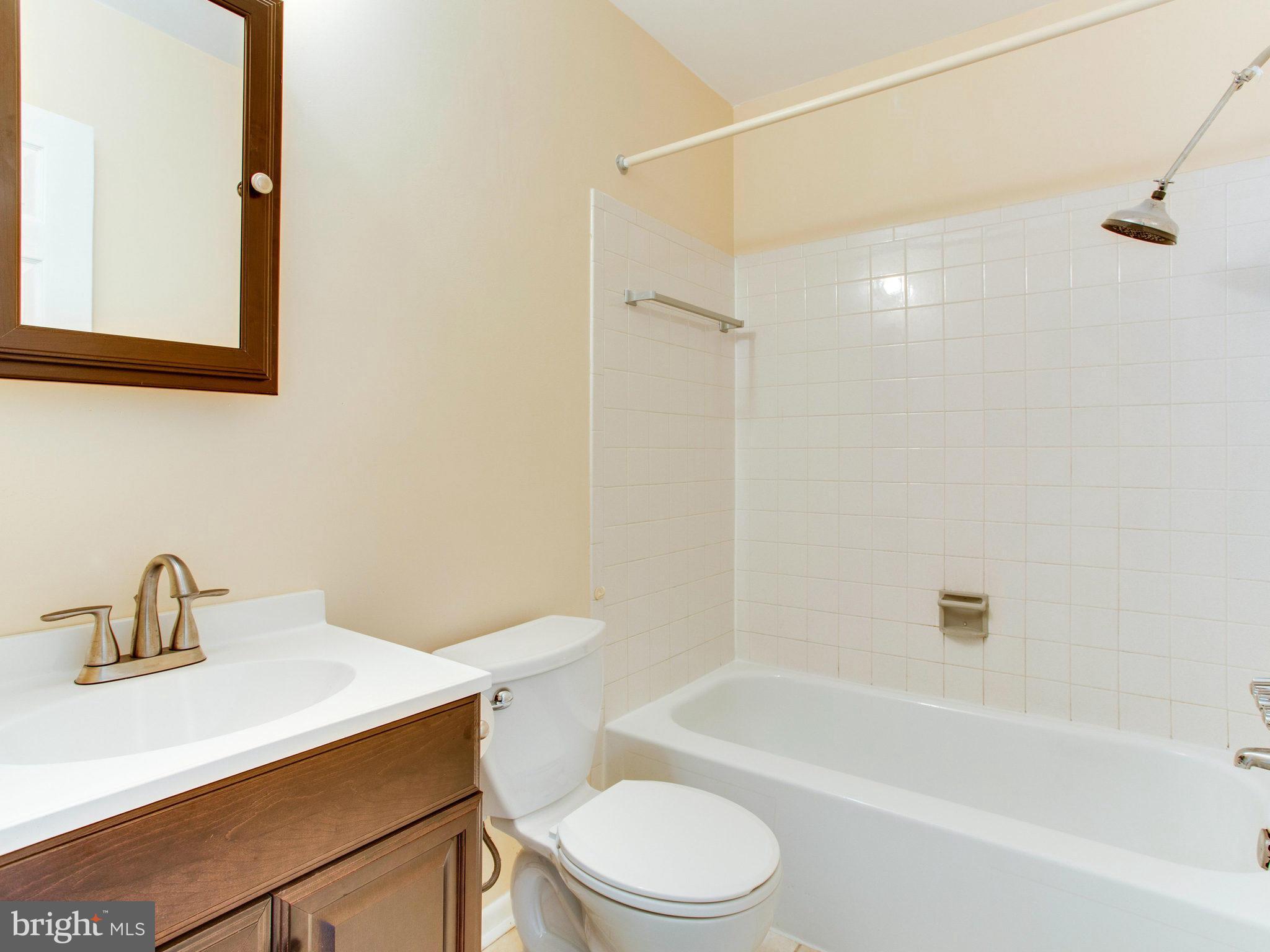 2308 St Bedes Court Reston, VA 20191 - Photo 20 of 30 a white toilet sitting next to a bath tub