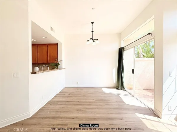 a view of a room with wooden floor and windows