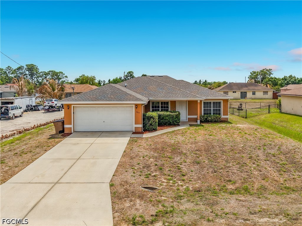 3713 20th Street Southwest Lehigh Acres, FL 33976 - Photo 1 of 23 a front view of a house with a yard