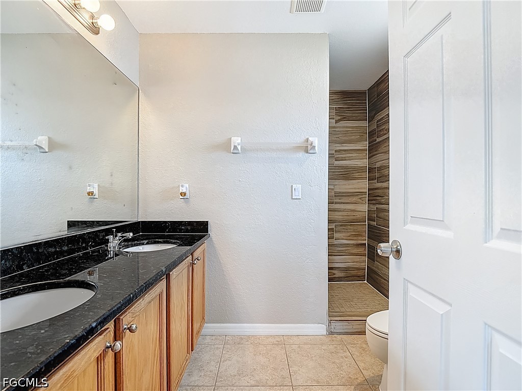 3713 20th Street Southwest Lehigh Acres, FL 33976 - Photo 12 of 23 a bathroom with a granite countertop sink and a mirror