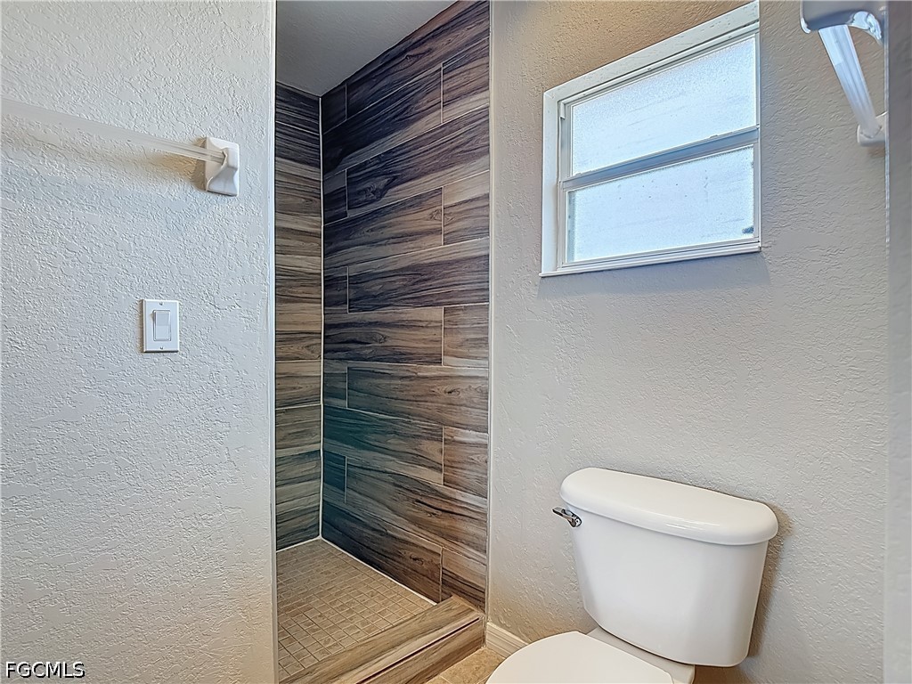 3713 20th Street Southwest Lehigh Acres, FL 33976 - Photo 13 of 23 a bathroom with a toilet and a shower