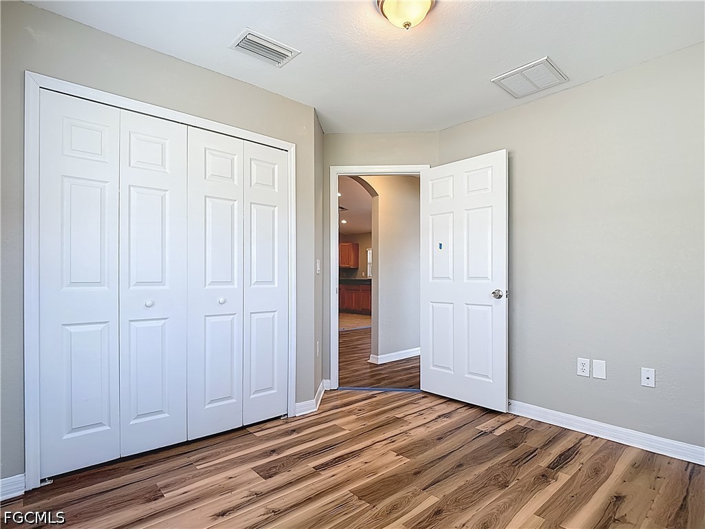 3713 20th Street Southwest Lehigh Acres, FL 33976 - Photo 14 of 23 a view of a livingroom with wooden floor and closet