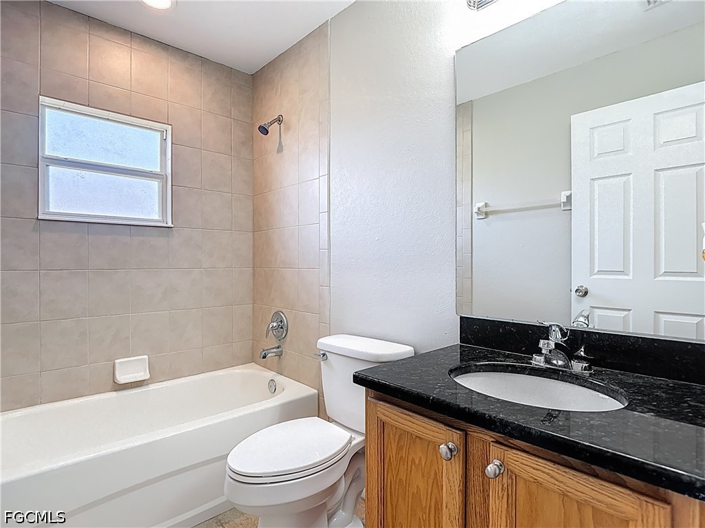 3713 20th Street Southwest Lehigh Acres, FL 33976 - Photo 15 of 23 a bathroom with a granite countertop sink toilet and shower
