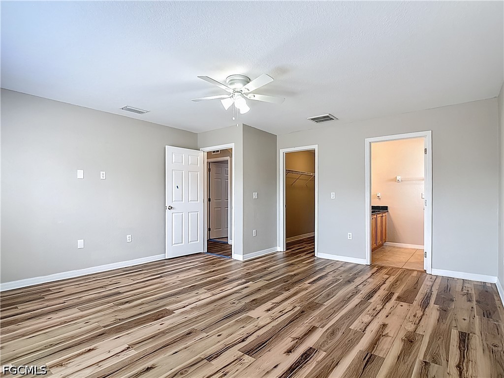 3713 20th Street Southwest Lehigh Acres, FL 33976 - Photo 18 of 23 a view of an empty room with wooden floor