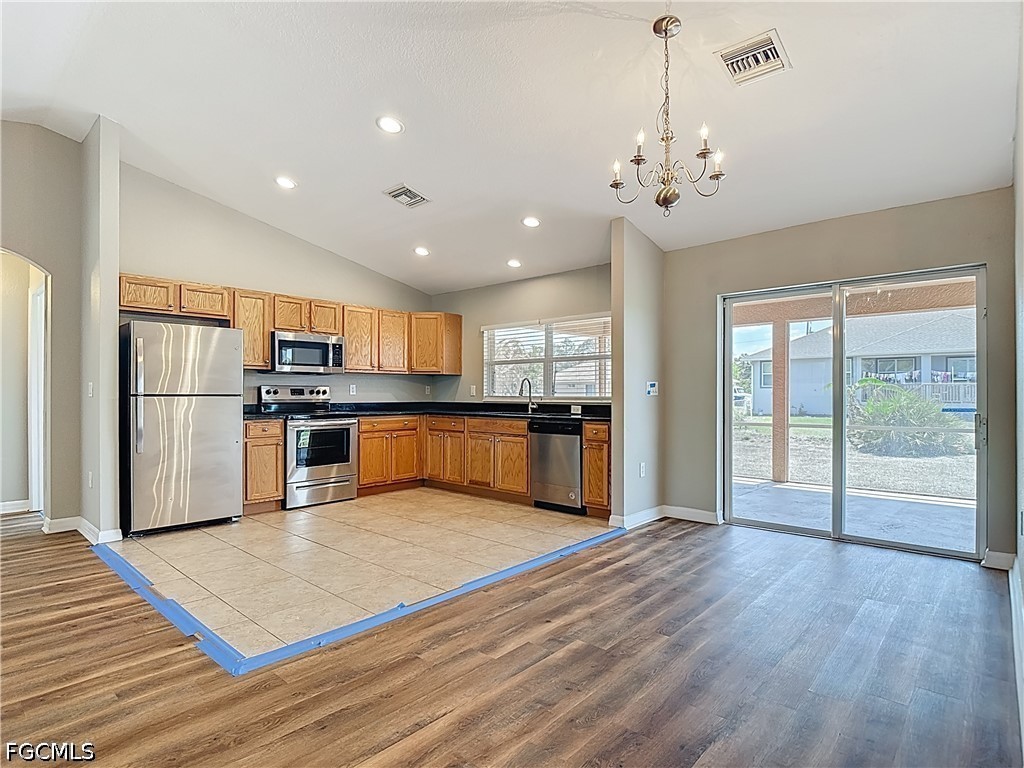 3713 20th Street Southwest Lehigh Acres, FL 33976 - Photo 5 of 23 a view of kitchen with granite countertop stainless steel appliances and wooden floor