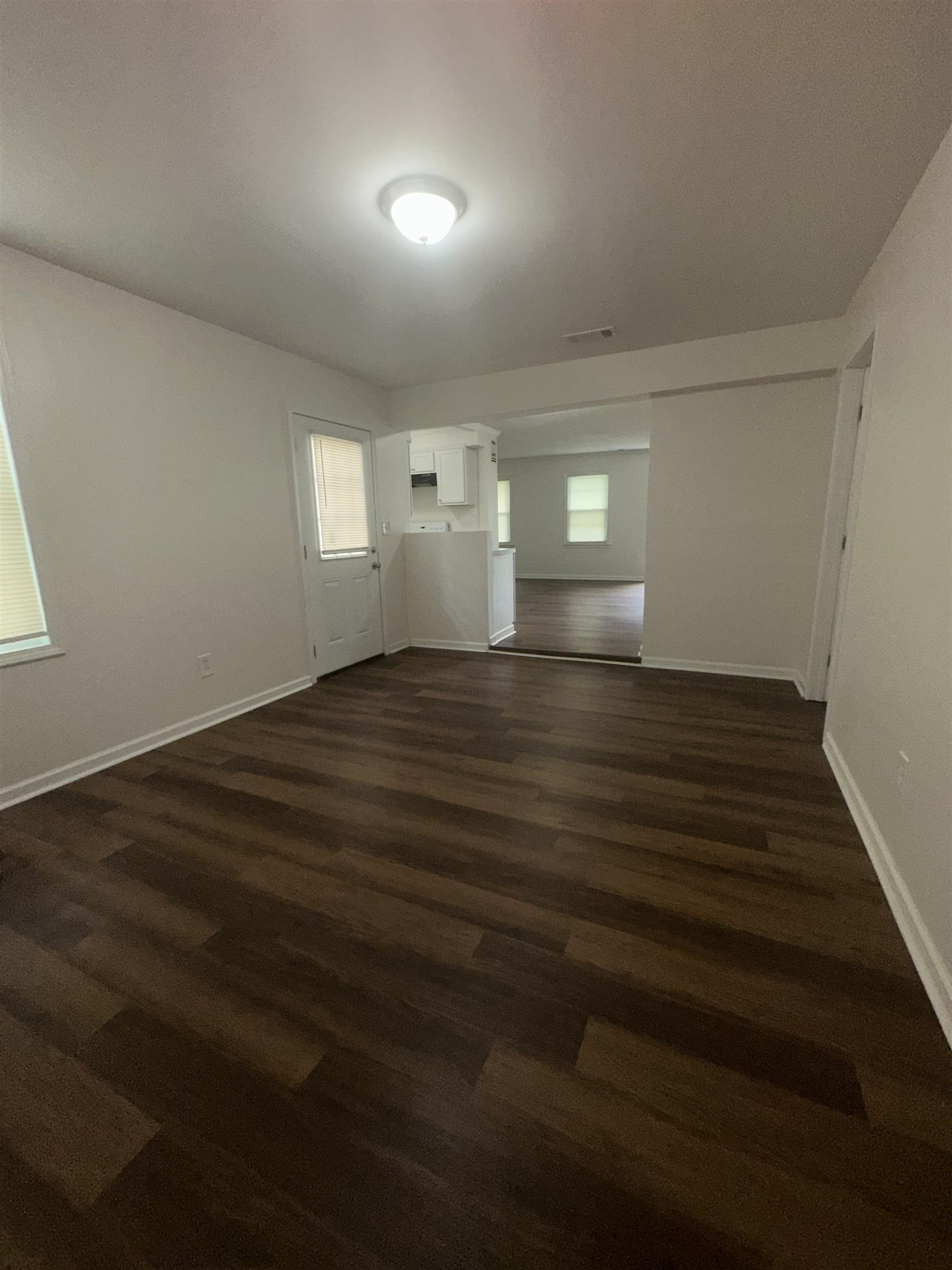 4545 Verne Road Memphis, TN 38117 - Photo 7 of 10 Spacious interior room featuring dark wood-finish flooring, white baseboards, and neutral wall paint