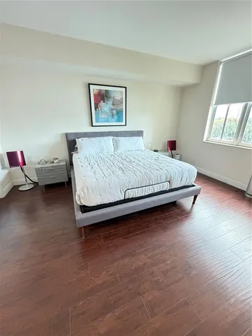 a bed sitting in a bedroom next to a window