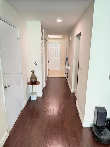 a view of a room with wooden floor and furniture