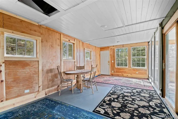 a large room with a bed and large windows