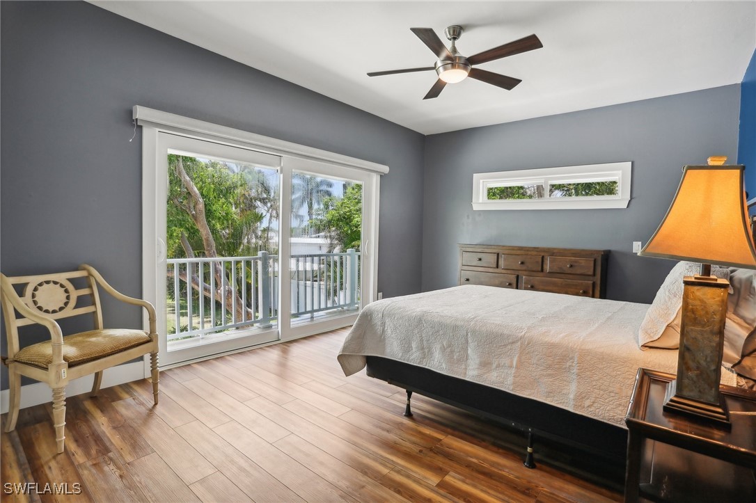 8335 Main Street Bokeelia, FL 33922 - Photo 36 of 47 a bedroom with a bed and wooden floor