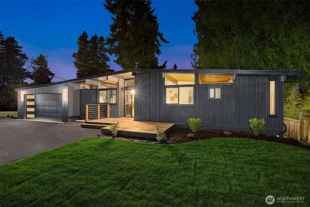 a backyard of a house with table and chairs with wooden fence
