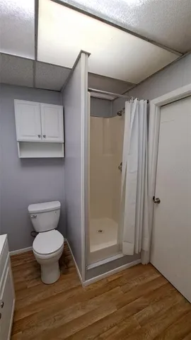 a bathroom with a sink a toilet and a window
