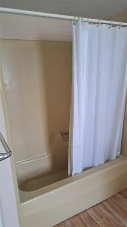 a kitchen with granite countertop white cabinets white appliances a sink and a window