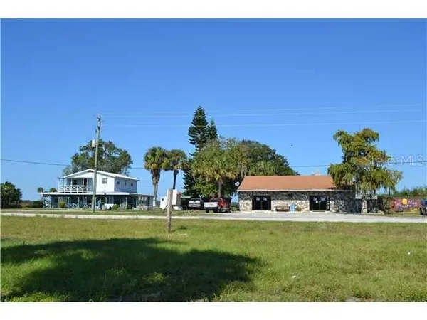 a view of house with a yard