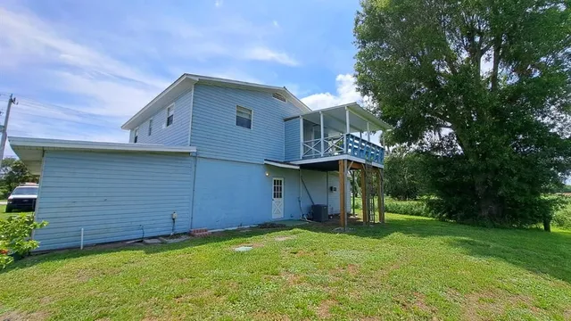 a view of a house next to a big yard