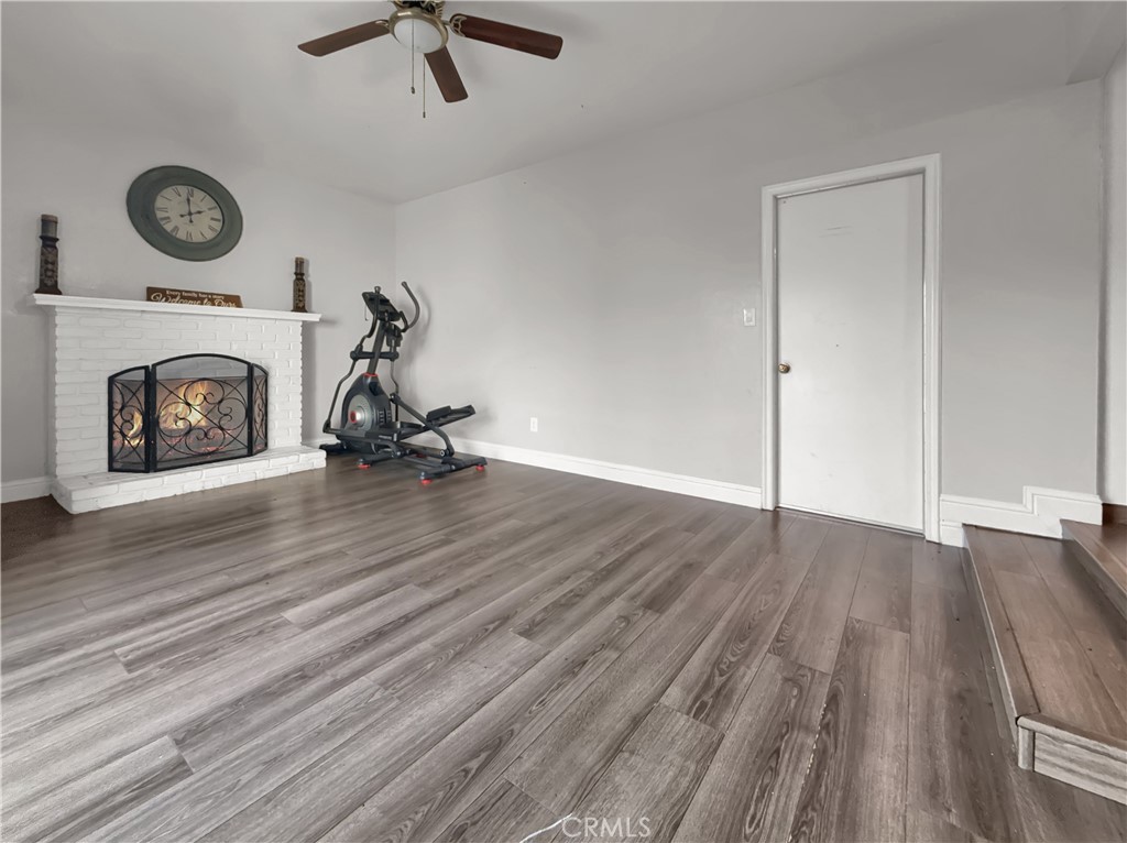 2846 North Parsons Merced, CA 95340 - Photo 7 of 29 an empty room with wooden floor and a fireplace