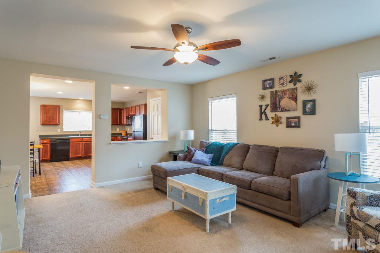 3404 Kernstown Drive Raleigh, NC 27610 - Photo 2 of 21 a living room with furniture and a chandelier