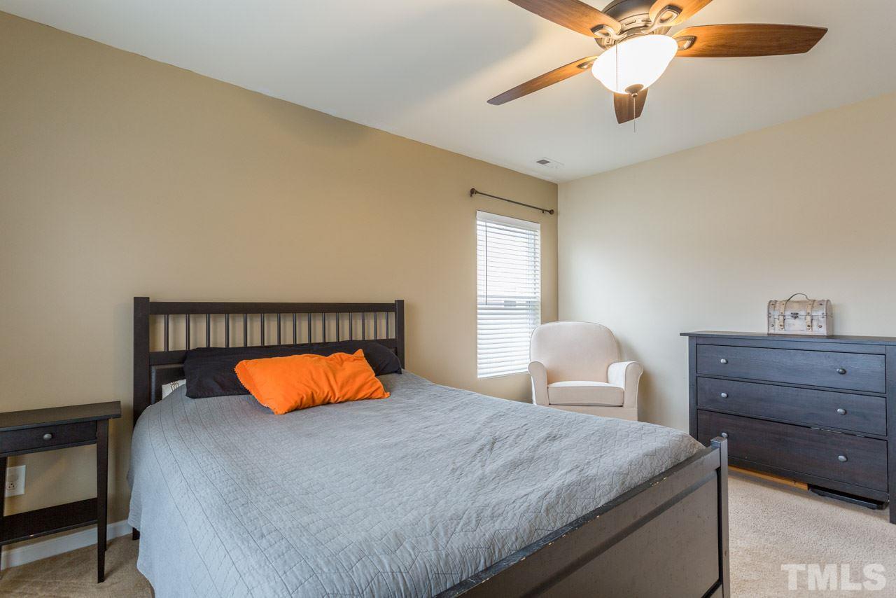 3404 Kernstown Drive Raleigh, NC 27610 - Photo 11 of 21 a bedroom with a bed and a chandelier