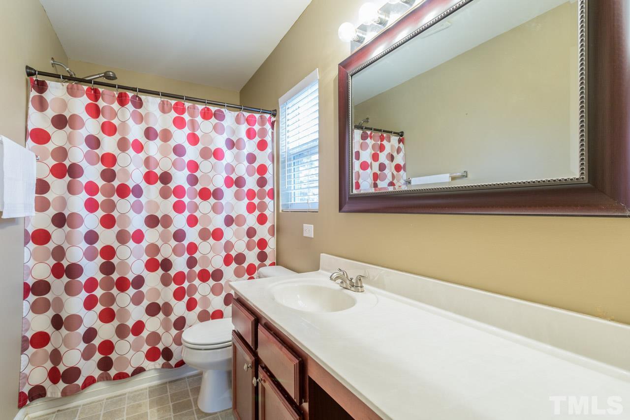 3404 Kernstown Drive Raleigh, NC 27610 - Photo 12 of 21 a bathroom with a sink and a mirror