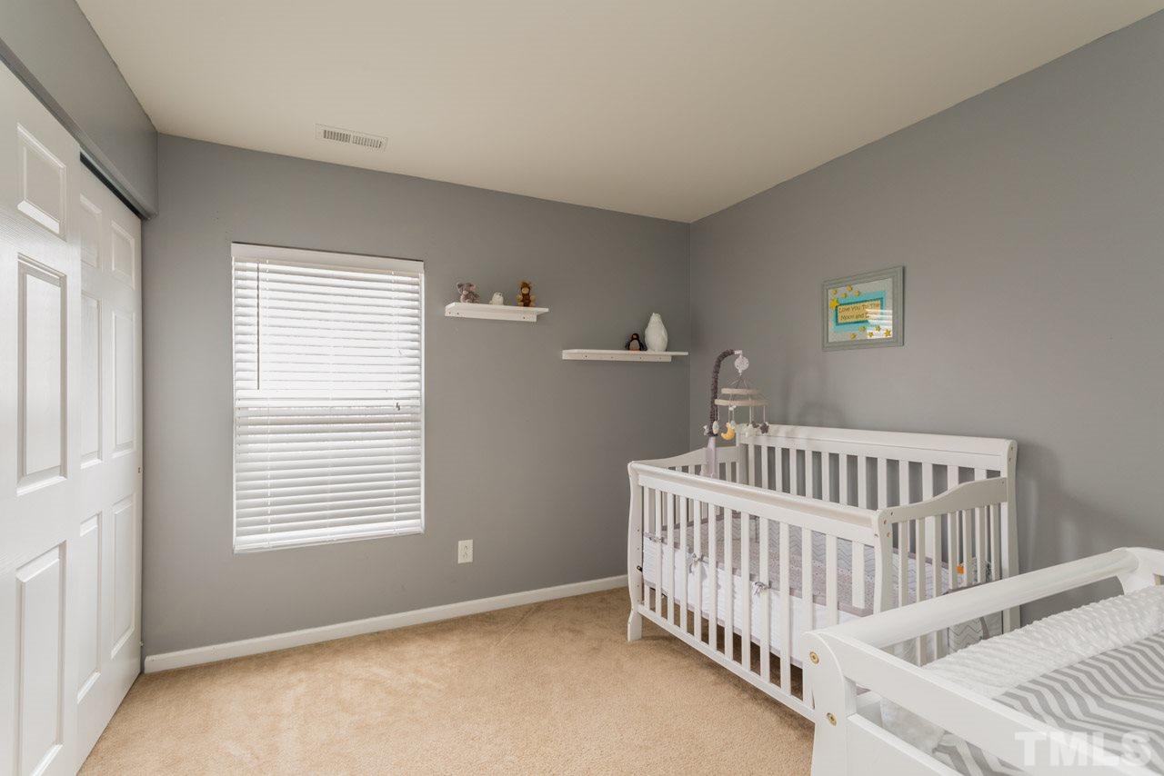 3404 Kernstown Drive Raleigh, NC 27610 - Photo 14 of 21 a bedroom with a bed and a window