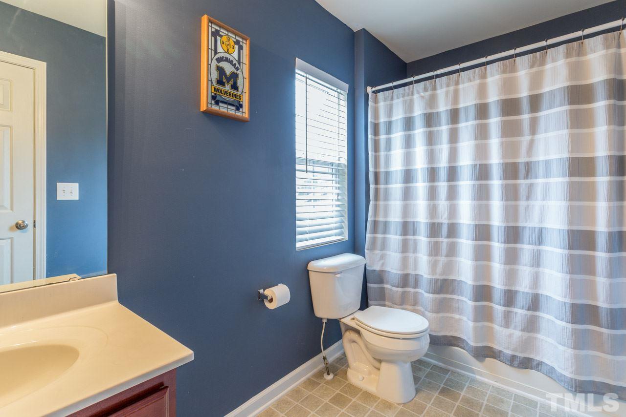 3404 Kernstown Drive Raleigh, NC 27610 - Photo 15 of 21 a bathroom with a toilet a sink and a shower