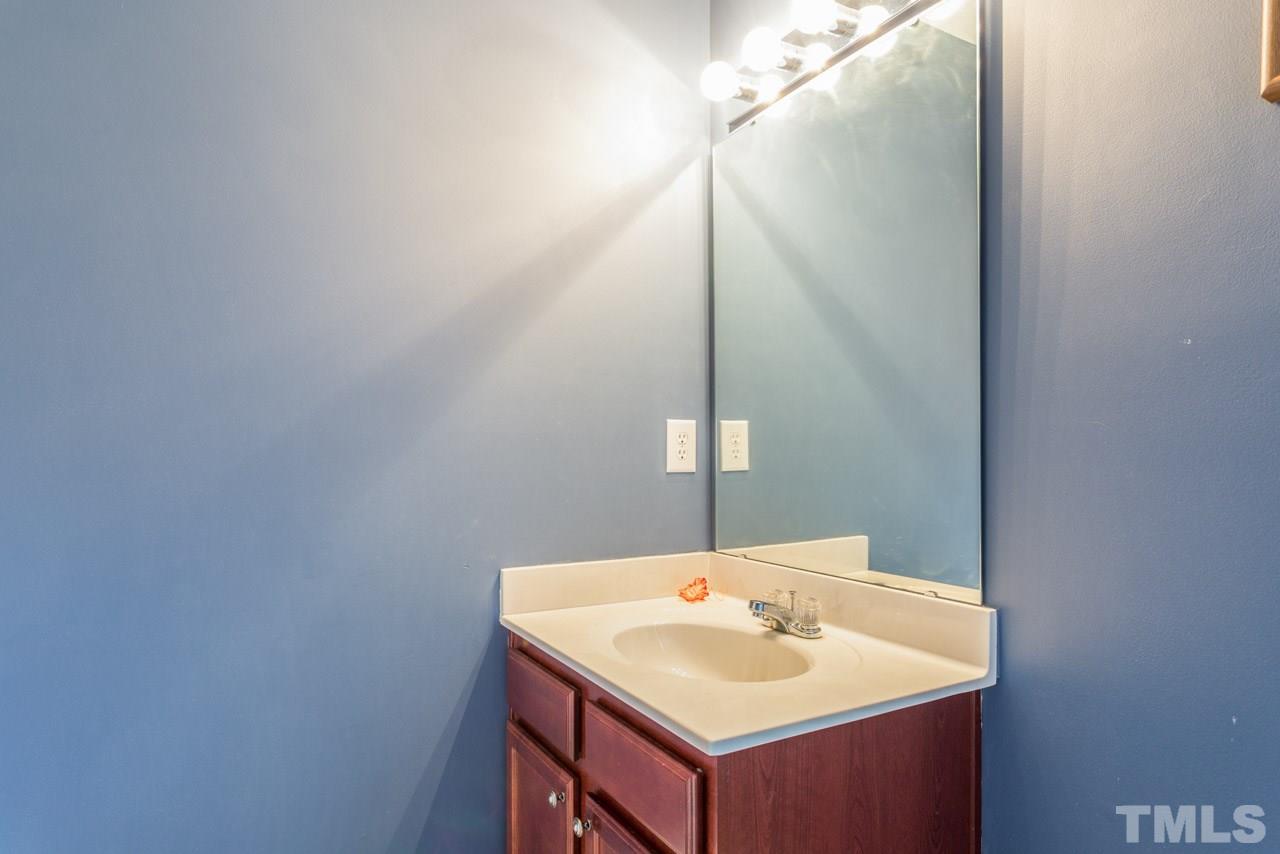 3404 Kernstown Drive Raleigh, NC 27610 - Photo 16 of 21 a bathroom with a sink and a mirror
