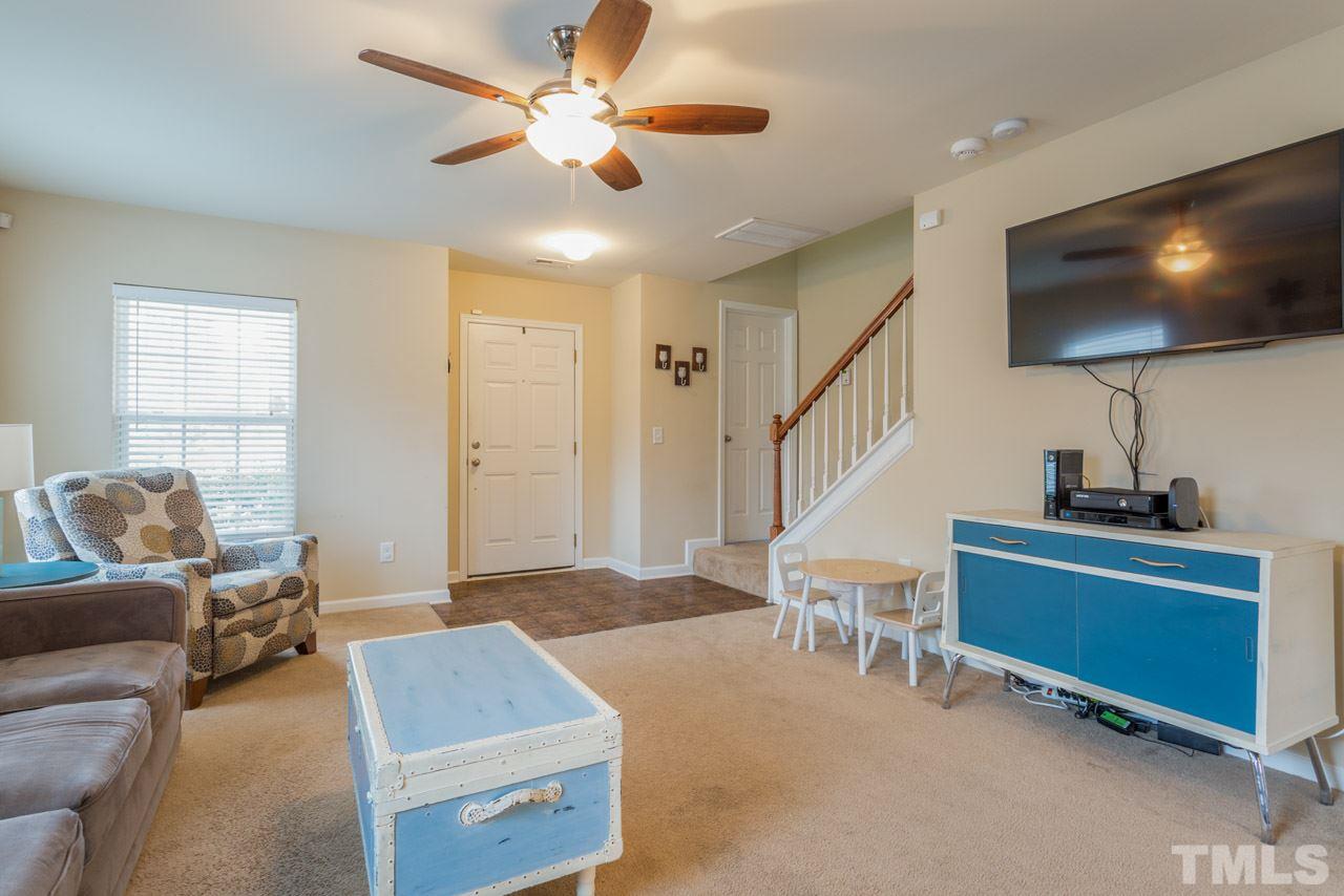 3404 Kernstown Drive Raleigh, NC 27610 - Photo 20 of 21 a living room with furniture and a flat screen tv