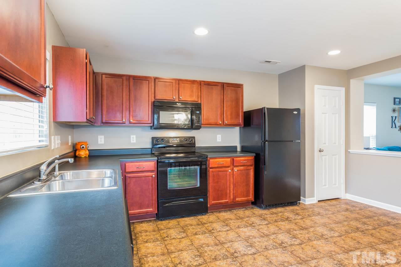 3404 Kernstown Drive Raleigh, NC 27610 - Photo 21 of 21 a kitchen with stainless steel appliances granite countertop a refrigerator stove top oven a sink and dishwasher